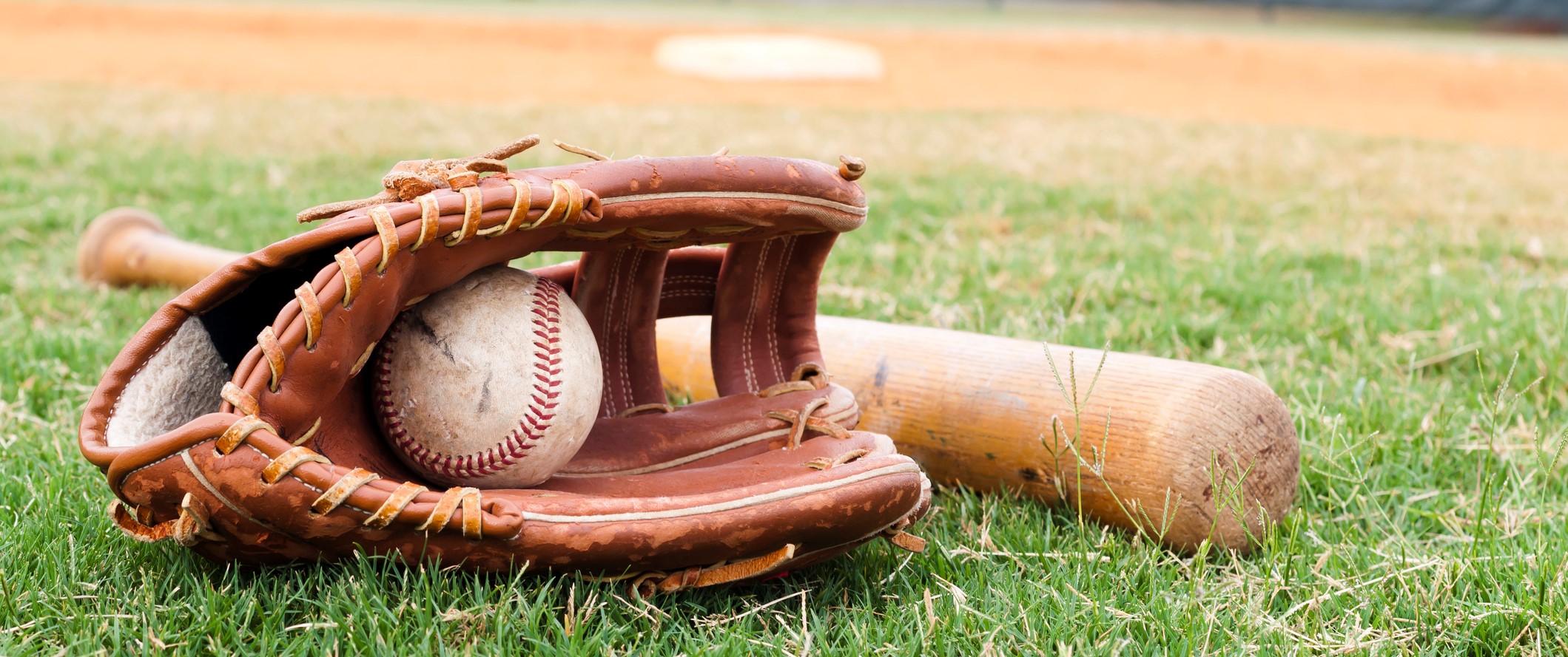Old Baseball, Glove, and Bat on Field